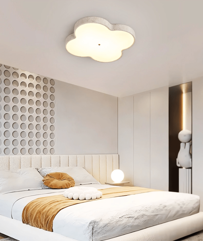 Cloud ceiling lamp lit in a bedroom with a slatted wall panel and a tan throw