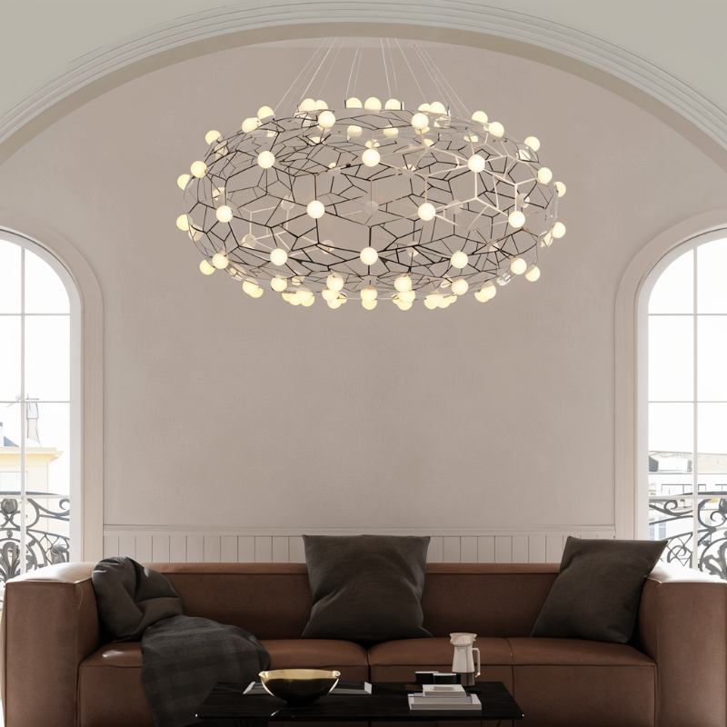 The lit cloud above a brown sofa and coffee table below a tall arched window