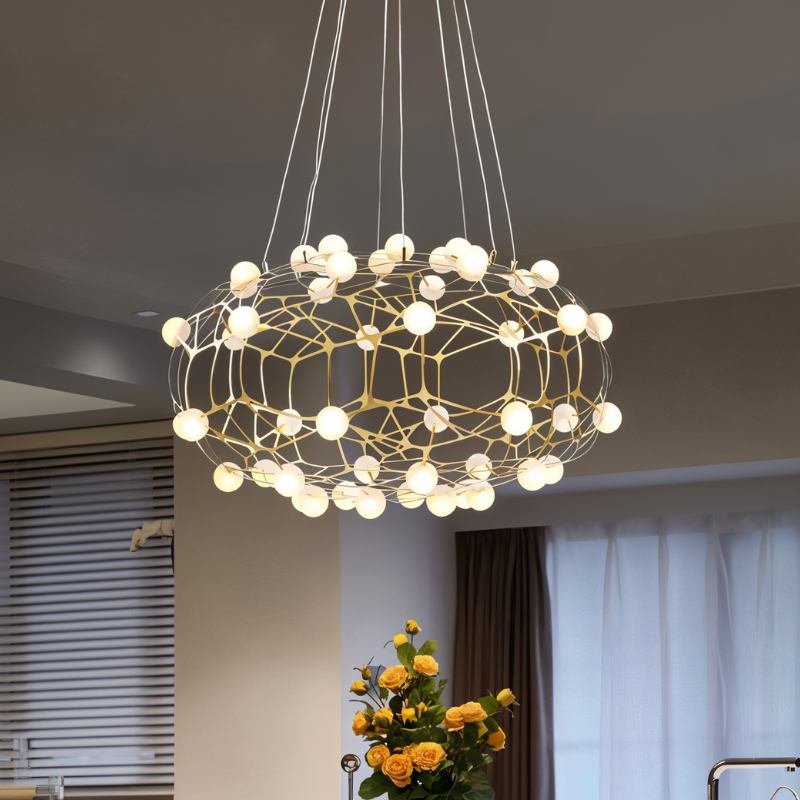 The cloud lit near a curtained window with orange flowers on a stand below
