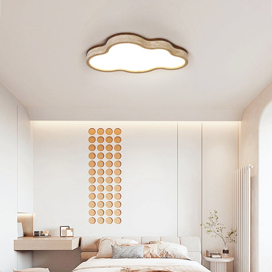 Cloud ceiling fixture lit in a bedroom with a beaded wall hanging and pale bedding