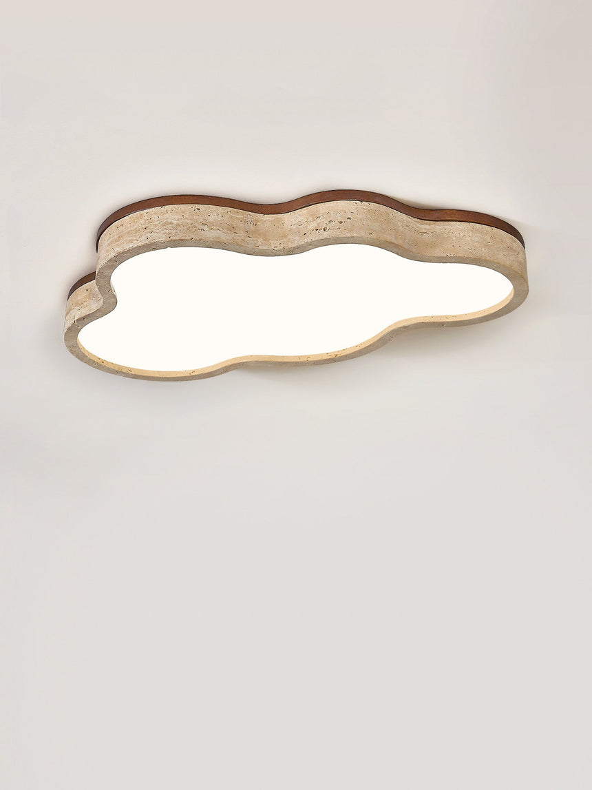 Cloud ceiling light seen at an angle, unlit, with the walnut edge over the stone band