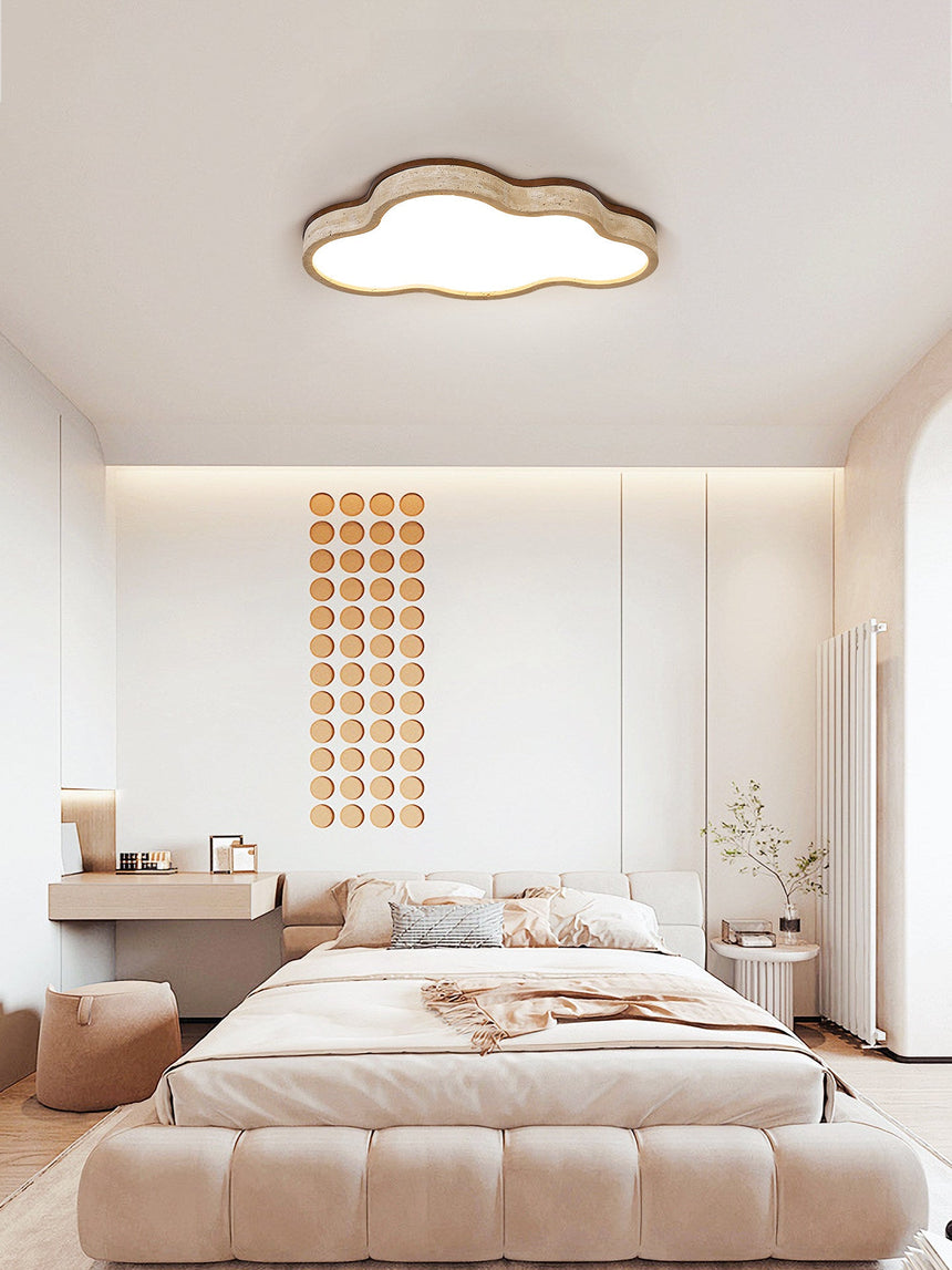 Cloud lamp ceiling fixture above a low bed in a bedroom with a beaded wall panel