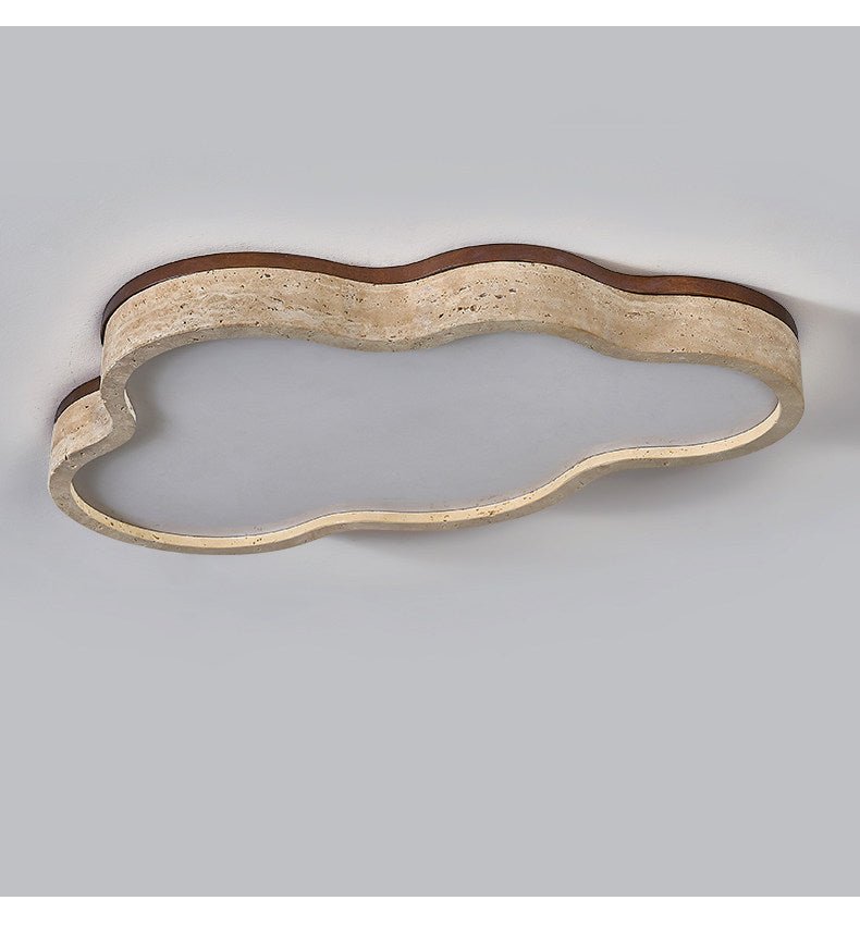 Underside view of the cloud ceiling light showing the porous travertine band