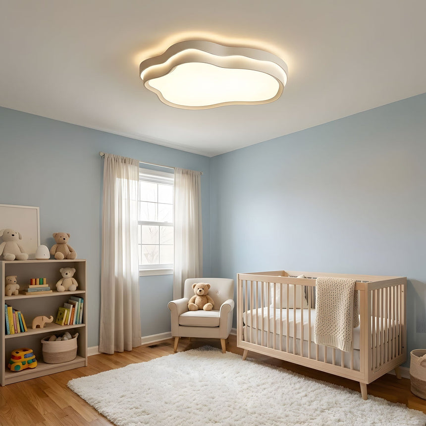 Cloud shaped ceiling fixture lit in a child's bedroom with a low bed and toys on a shelf