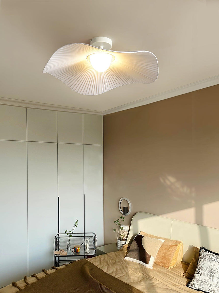 Ceiling light with fabric wings in a beige bedroom with a mirrored wardrobe