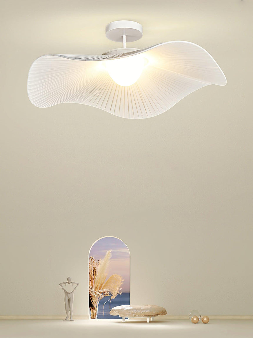 White fabric ceiling fixture lit in a styled beige scene with an arched niche