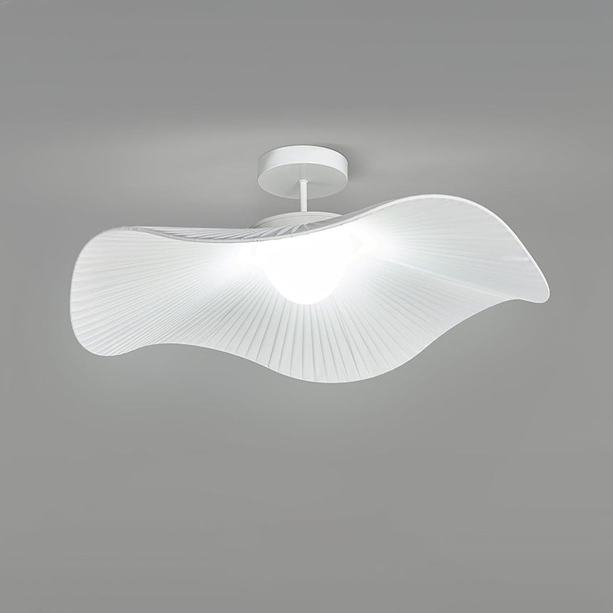 Unlit fabric wing ceiling fixture from a low side angle showing the pleated shade