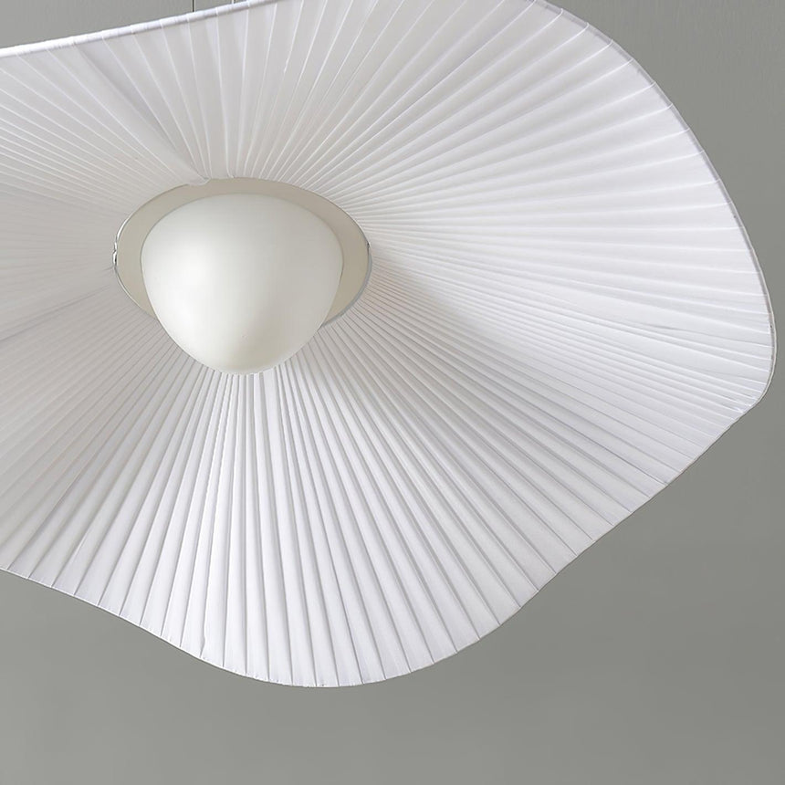 Close view from below of the fabric shade and the small white ceiling canopy