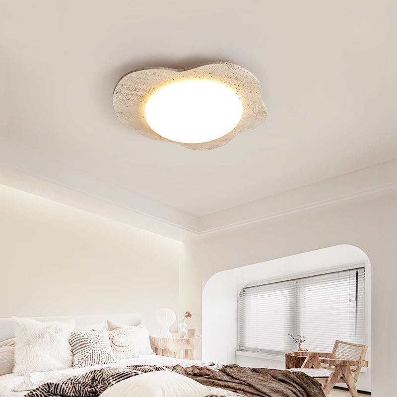 Cloud ceiling light in travertine seen from below in a bedroom with an arched window