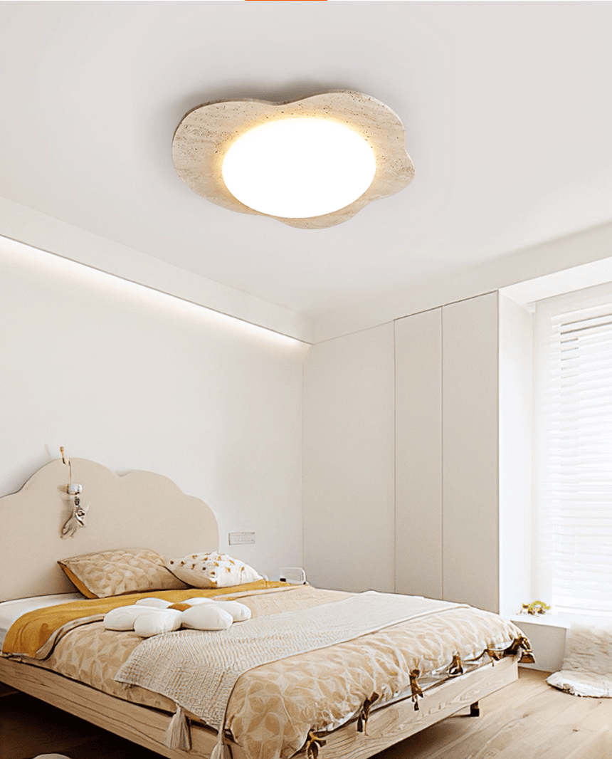 Cloud shaped ceiling fixture above a bed with a rattan headboard and yellow cushions