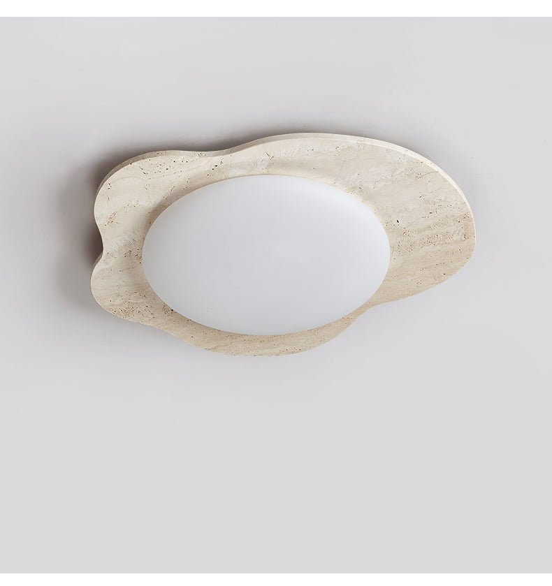 Unlit travertine cloud ceiling light showing the matte white lens against the stone