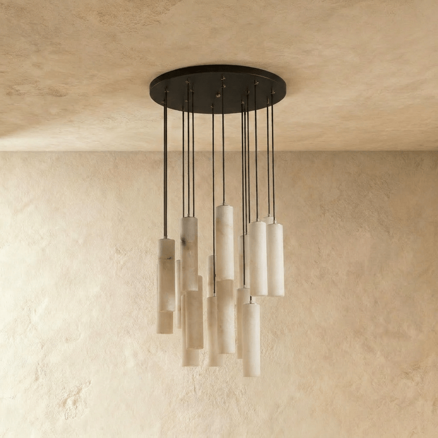 A large cluster of alabaster cylinders unlit, each one on its own black cord