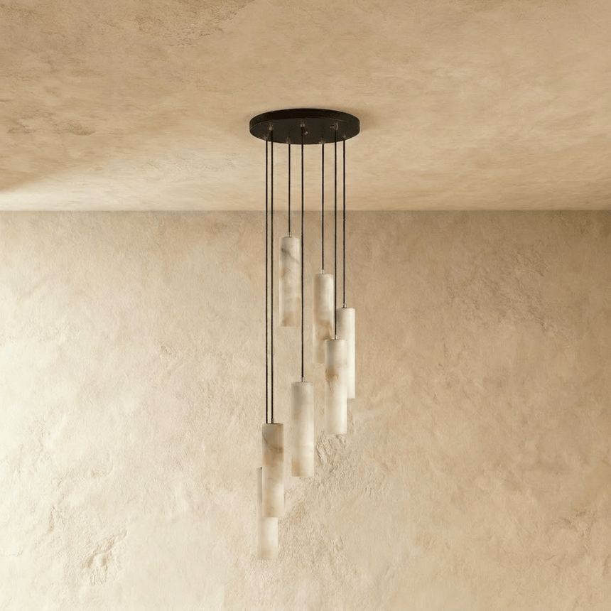 A long drop of unlit stone cylinders hung on cords of different lengths