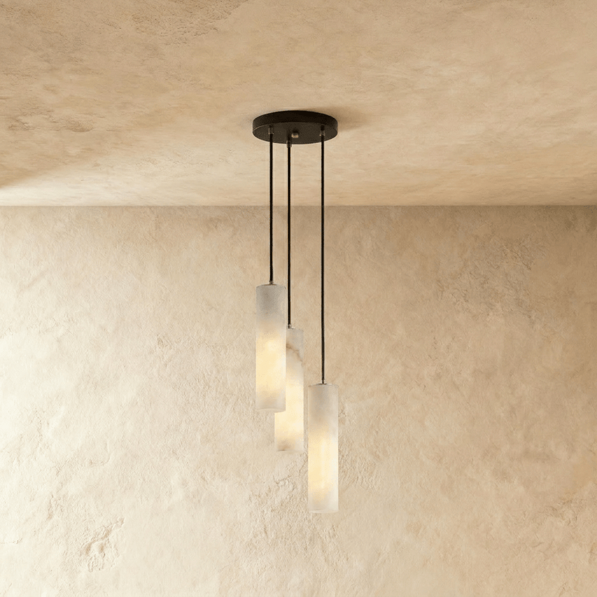 A short cluster of lit alabaster cylinders close under the ceiling plate