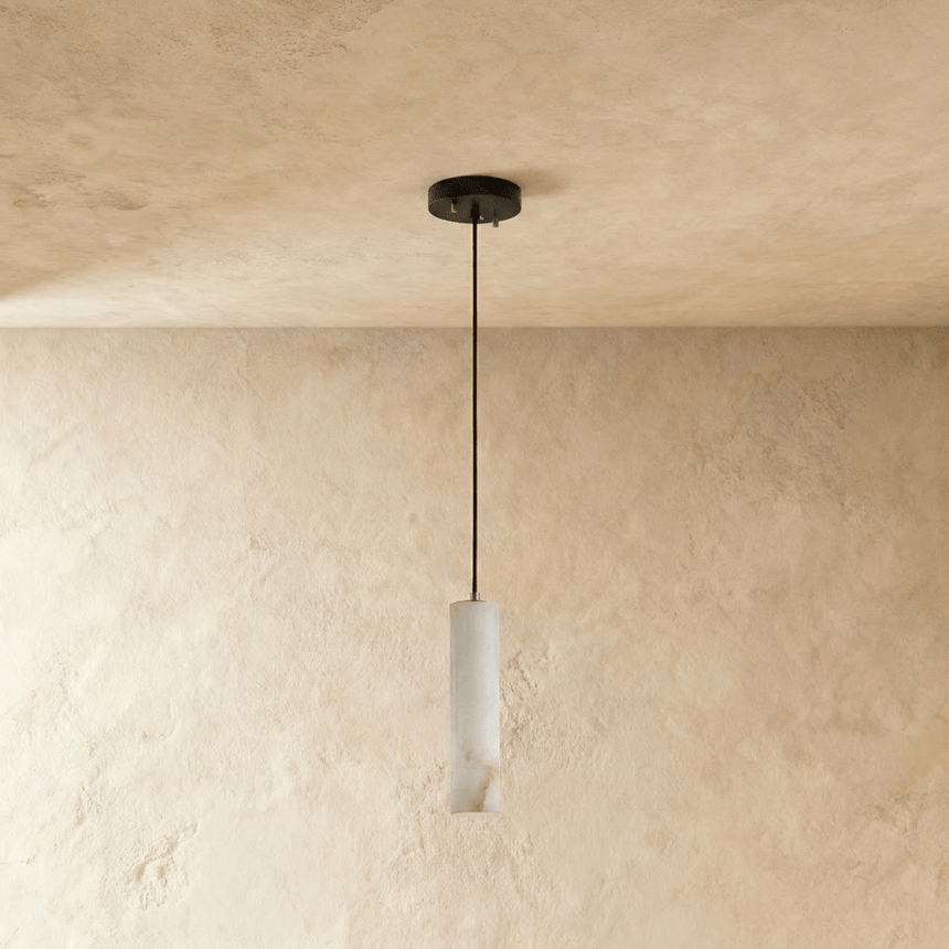 One unlit alabaster cylinder, the veining visible in the pale stone