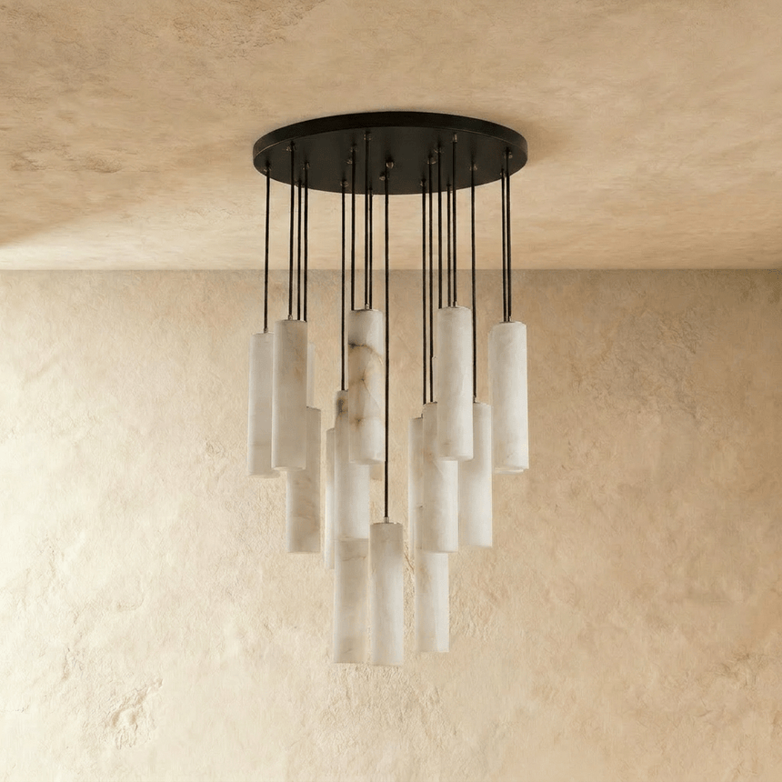The same wide cluster unlit, the stone cylinders pale against a plaster wall