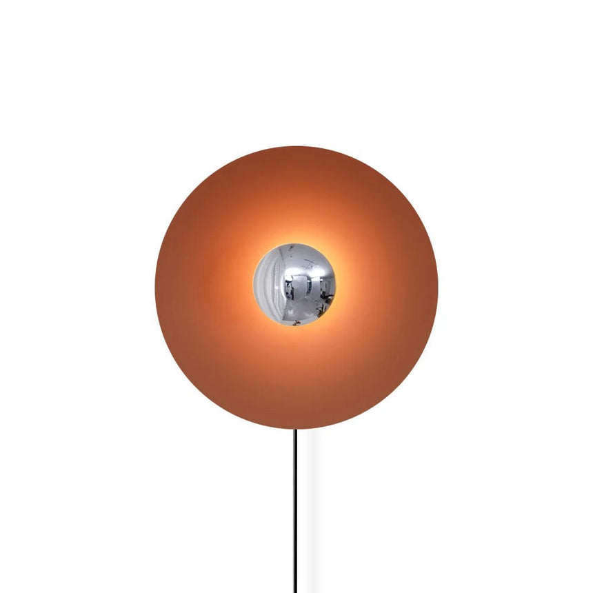The orange disc with a chrome center and its cord on a white background