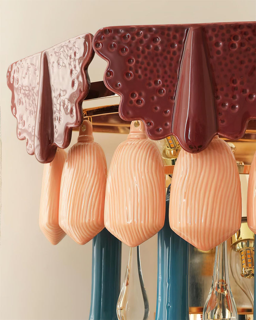 Close view of the pierced burgundy cap above ribbed peach ceramic drops