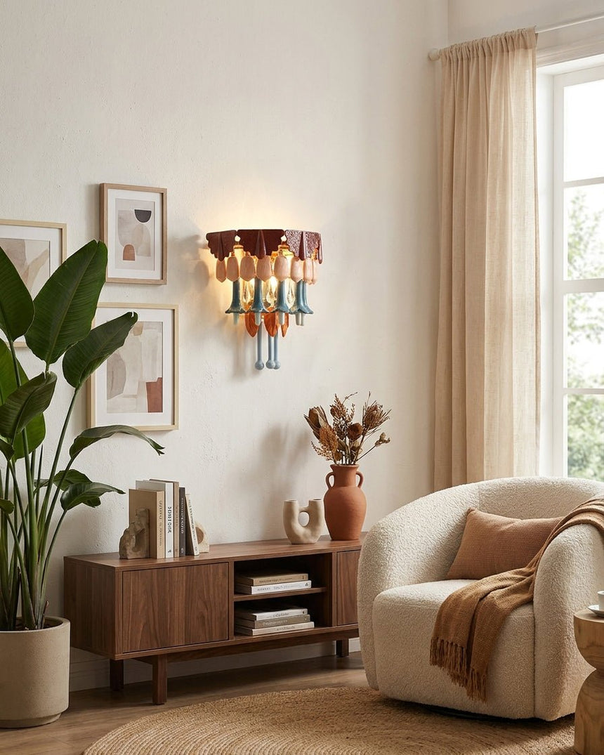 The sconce above a walnut media console in a bright living room with a plant