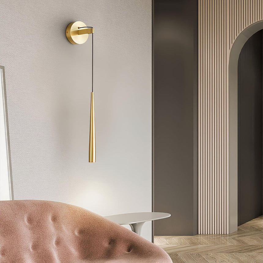 The brass cone beside an arched doorway above a pink tufted sofa