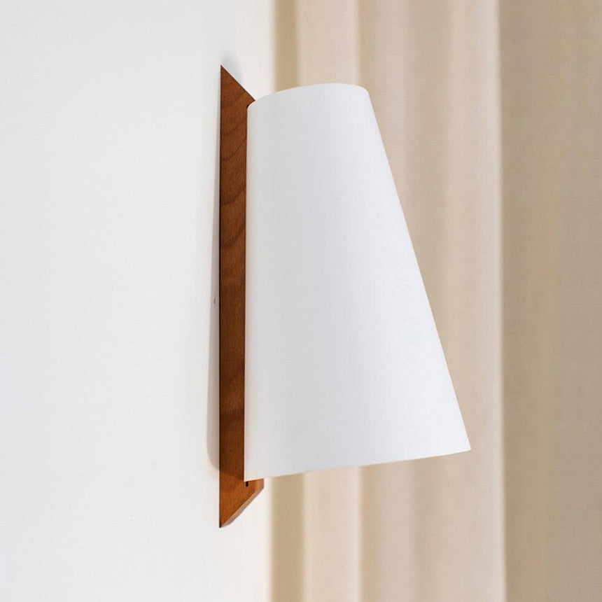 The white cone shade seen from the front, the wood bracket behind its edge