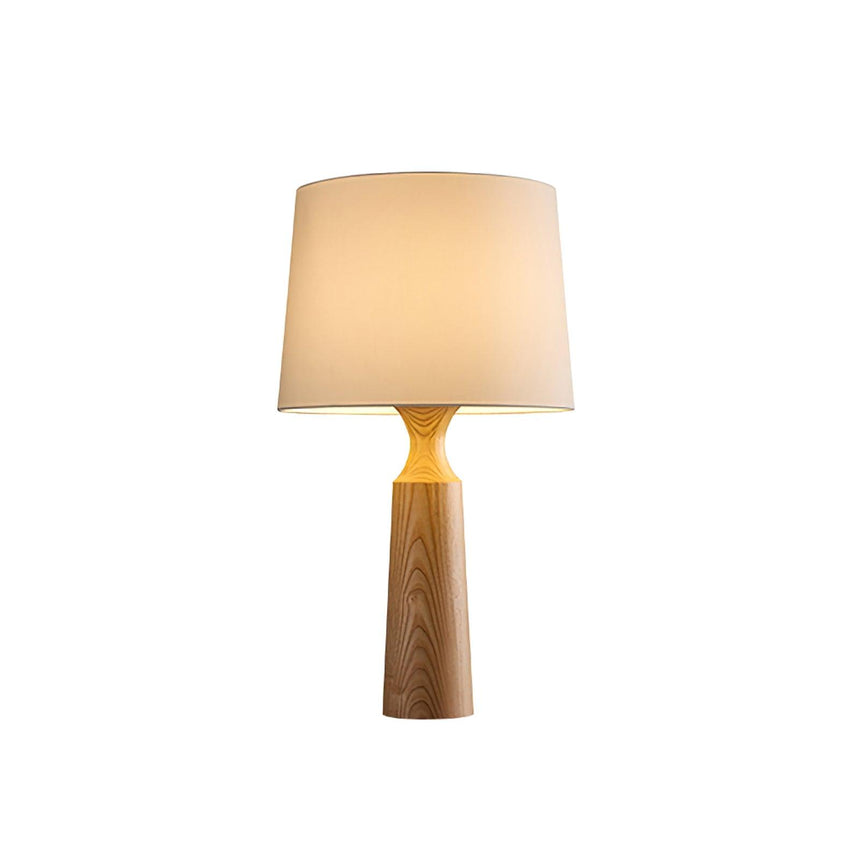 Console table lamp in light wood lit against a plain pale ground
