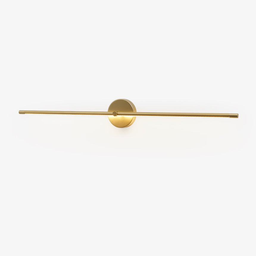 Slim gold rod crossing a round gold hub on a plain wall plate