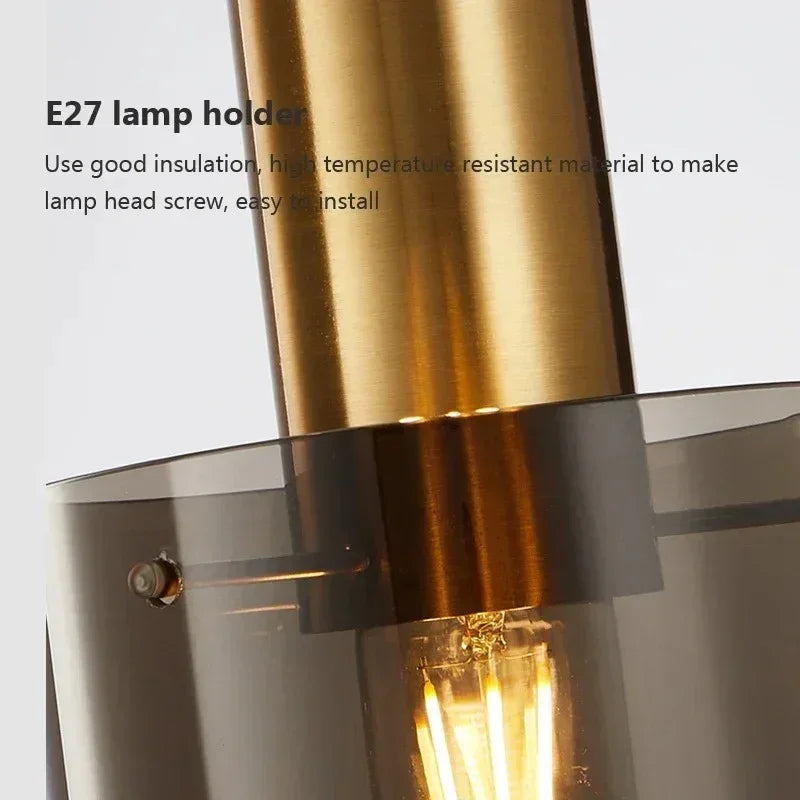 Close view of the brushed copper lamp holder above the smoked glass tube