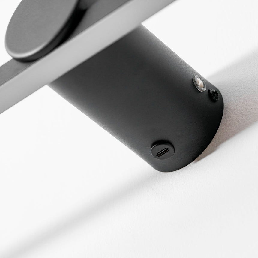 Close view of the round mount and the charging port on the back of the bar