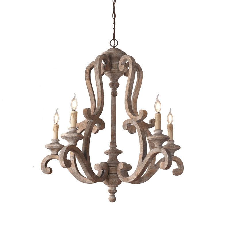The old gray finish against a pale wall, five candle arms on the carved wood frame