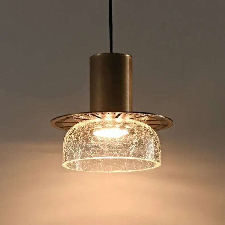 Close view of the fluted brass cap above the crackle glass shade
