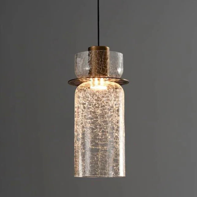 A tall clear crackle cylinder lit showing the brass holder inside it