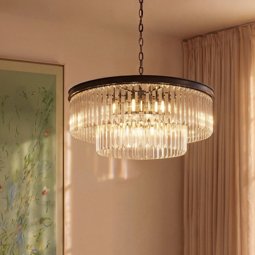 The round black version lit beside a long curtain and a framed artwork
