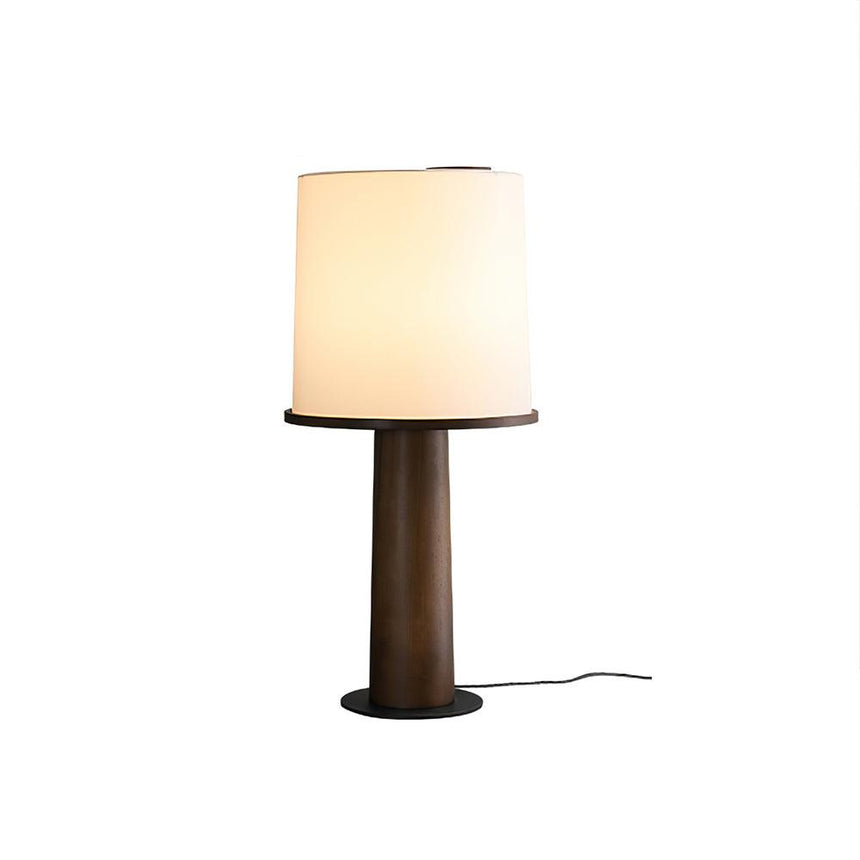 The walnut version of the cylinder table lamp, lit front view