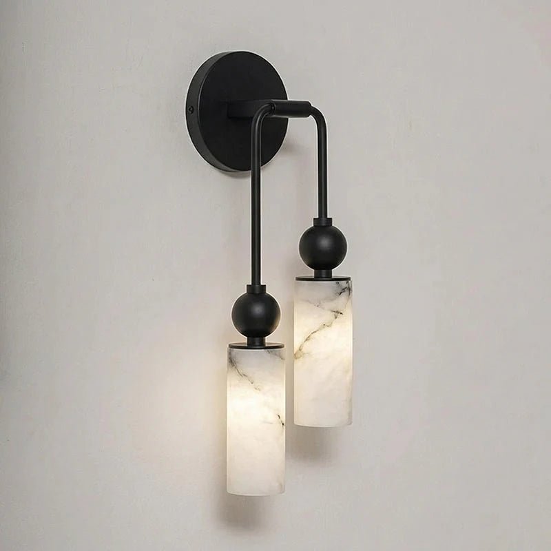 The black version with two lit stone cylinders on a plain wall