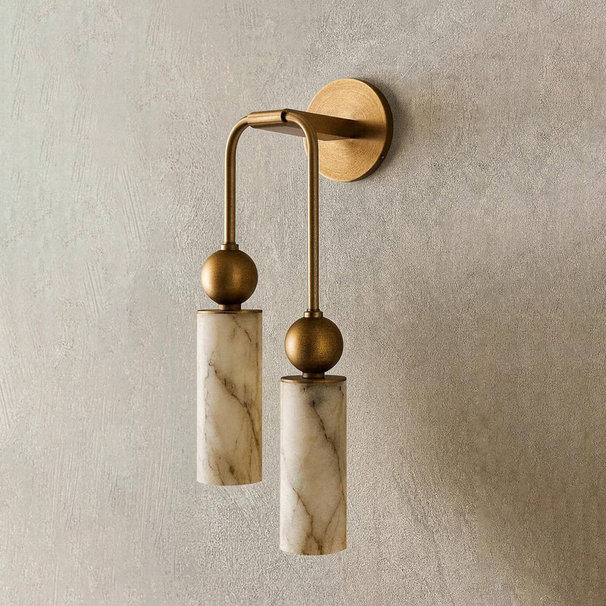 Two cylinders at different heights on a plaster wall above a bench