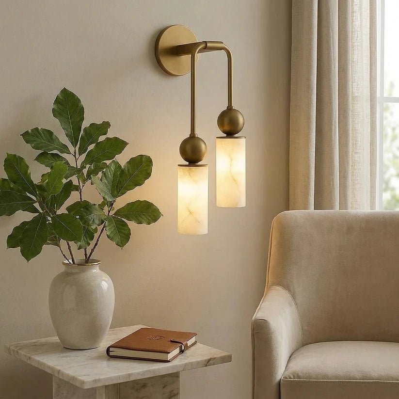 The light above a side table with a plant and a book beside a chair