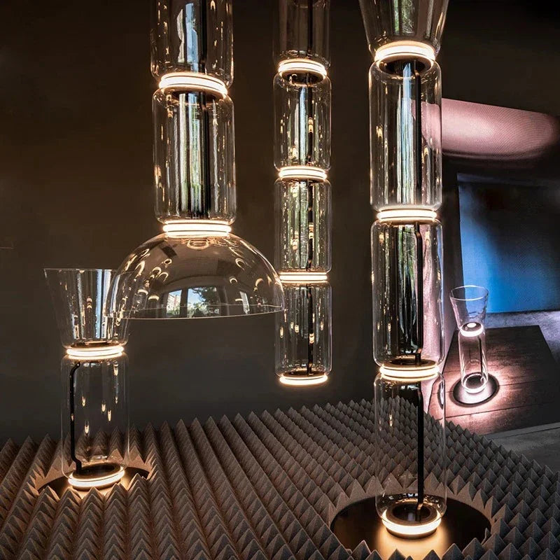 Several stacked cylinder pendants lit above a patterned table setting