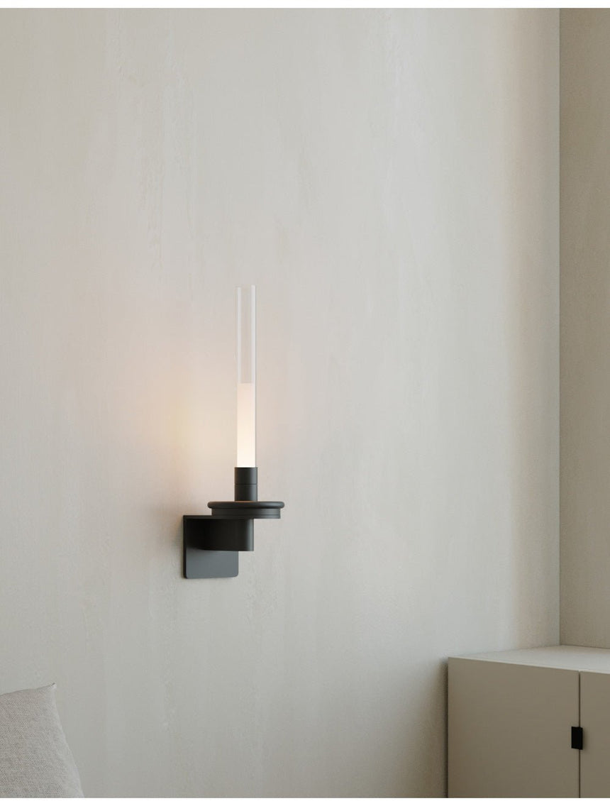 Lit in a bedroom corner above a low cabinet with a bed just in the frame