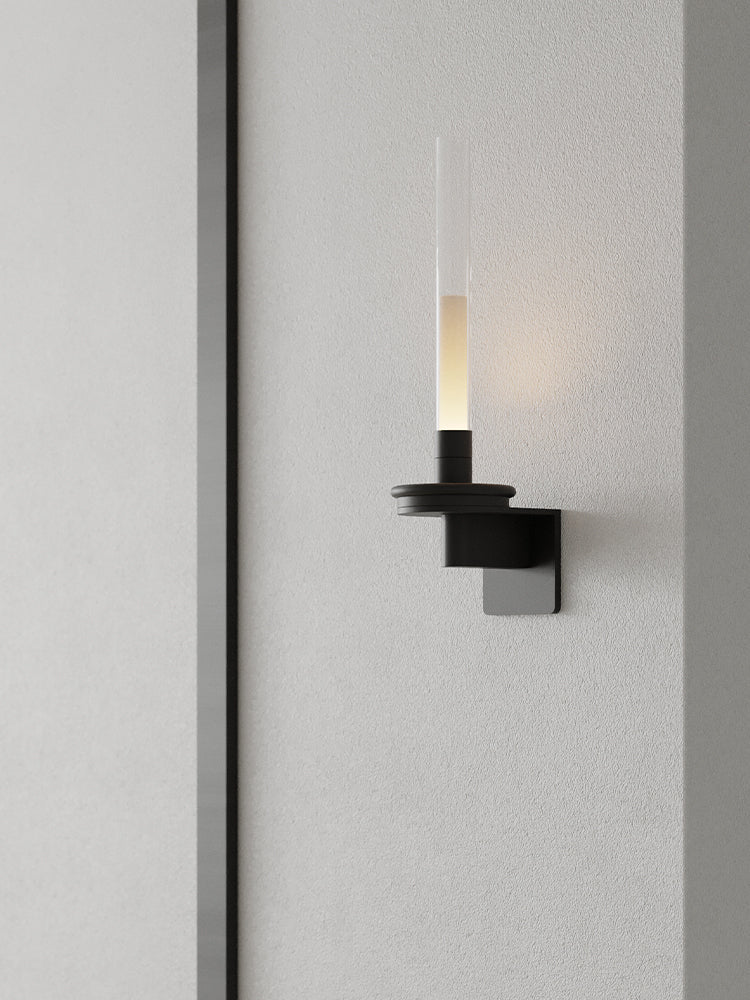 Lit on a fluted wall panel, the stem standing clear of the vertical grooves