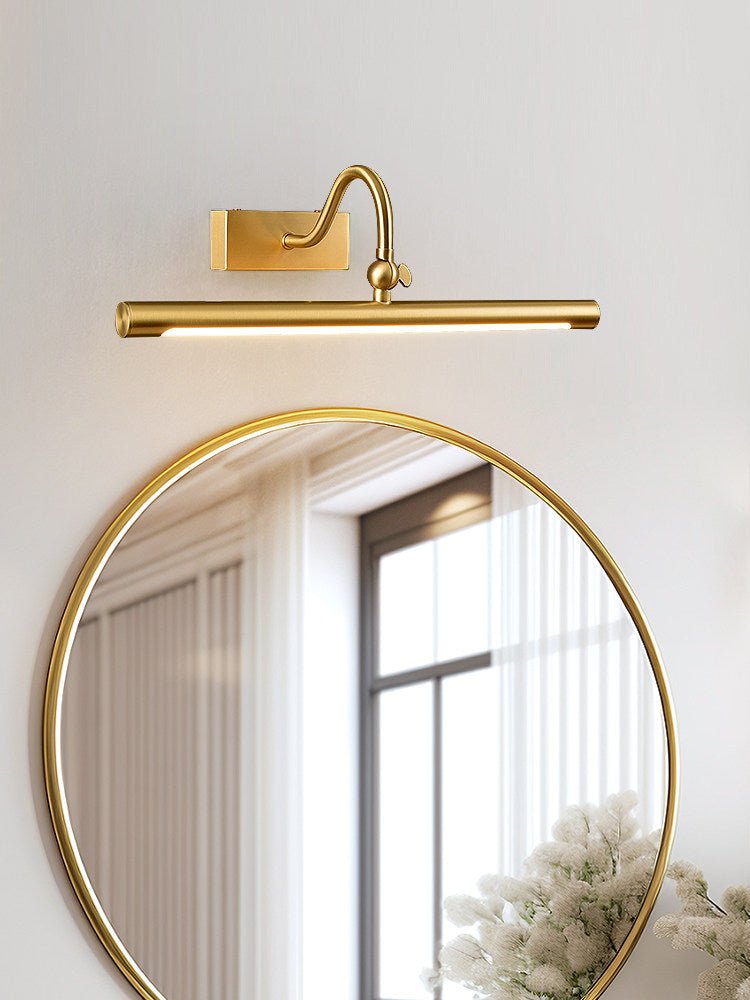 Brass bar above a round gold mirror with dried flowers on the counter