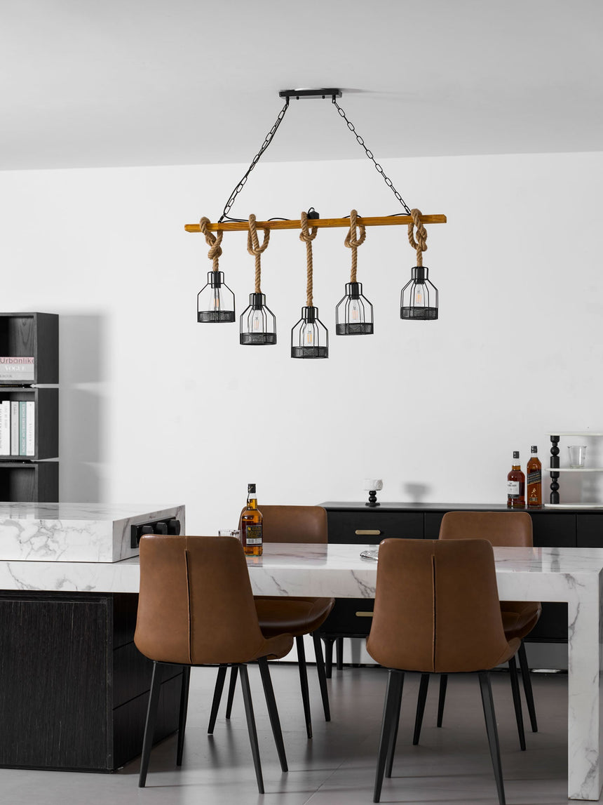 Chandelier hanging over a kitchen island with leather chairs around it