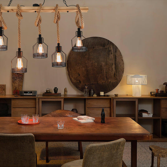 Chandelier lit over a wood dining table with chairs and a low sideboard