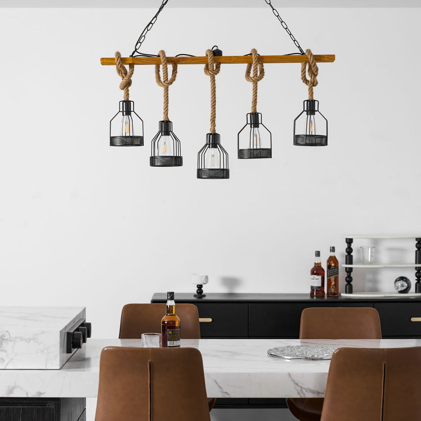 The beam lit above a marble island with tan chairs pulled up to it