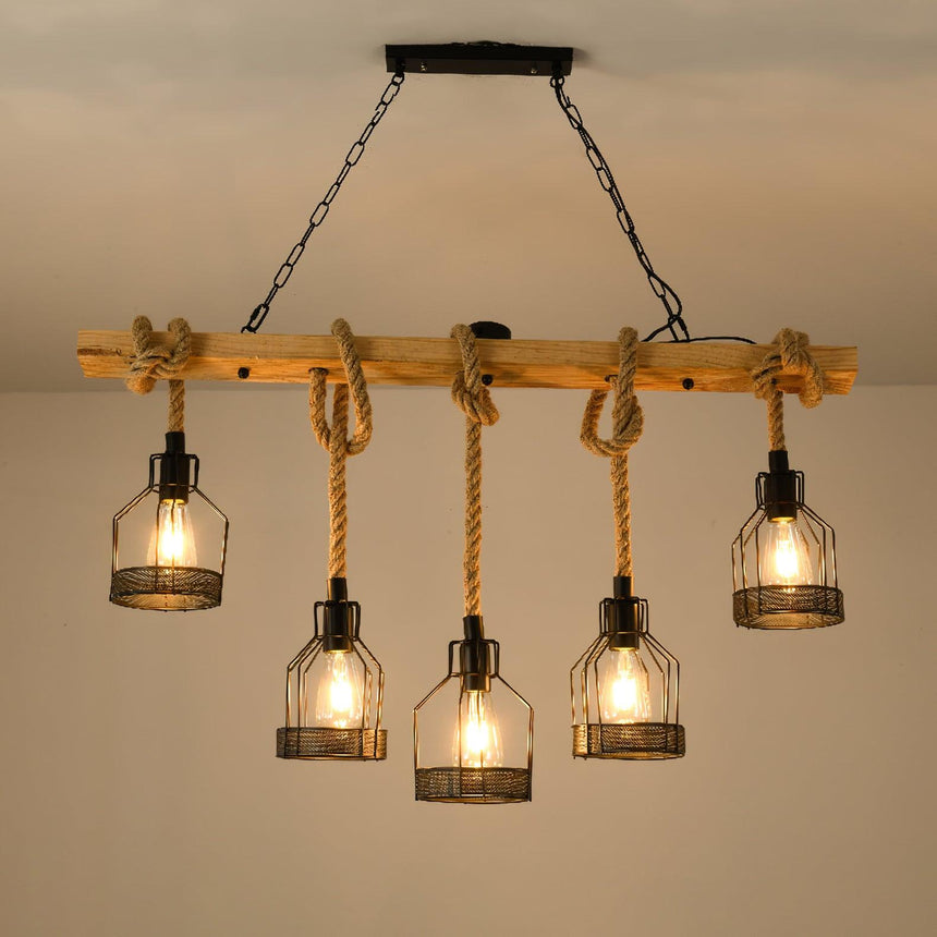 Chandelier lit close to a warm ceiling, cages and rope in full view