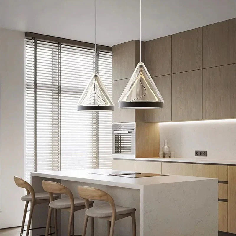 Two cone pendants lit above a pale kitchen island with bar stools