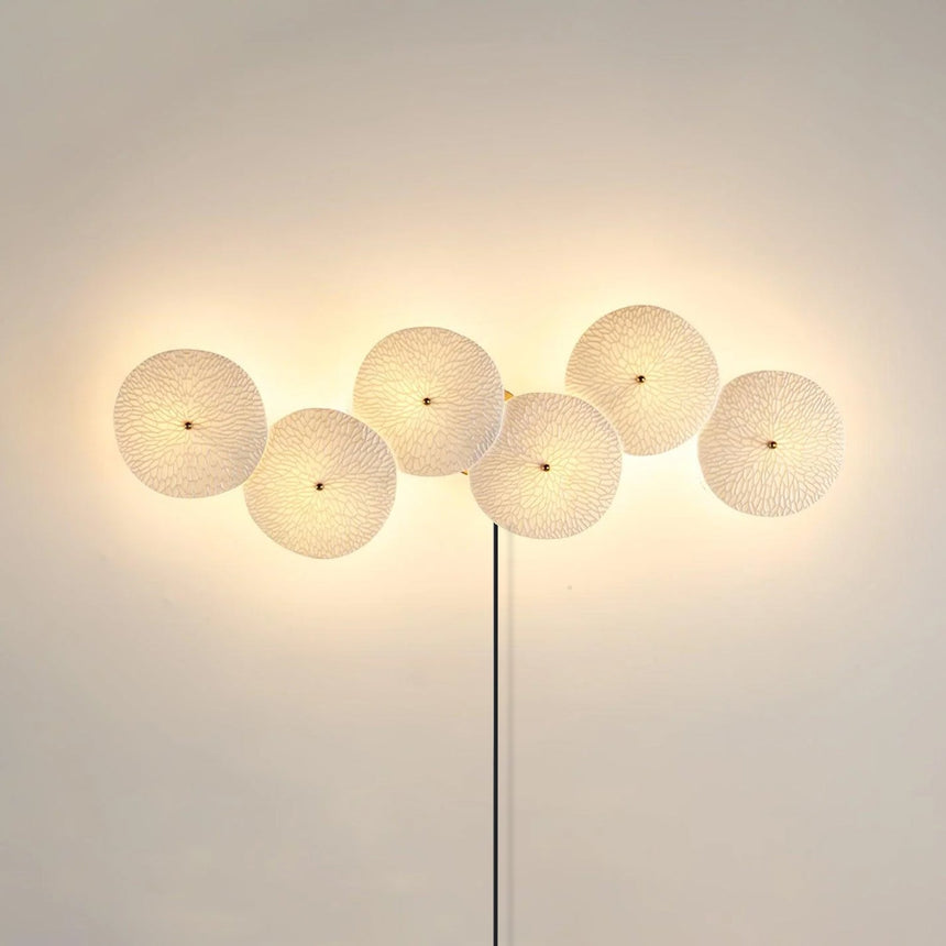 Six discs in a horizontal row, lit, the cord dropping from the center
