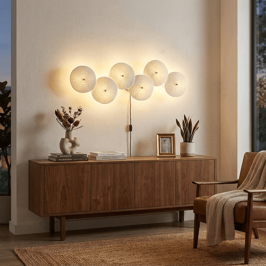 A horizontal row of discs lit above a walnut sideboard in a warm living room