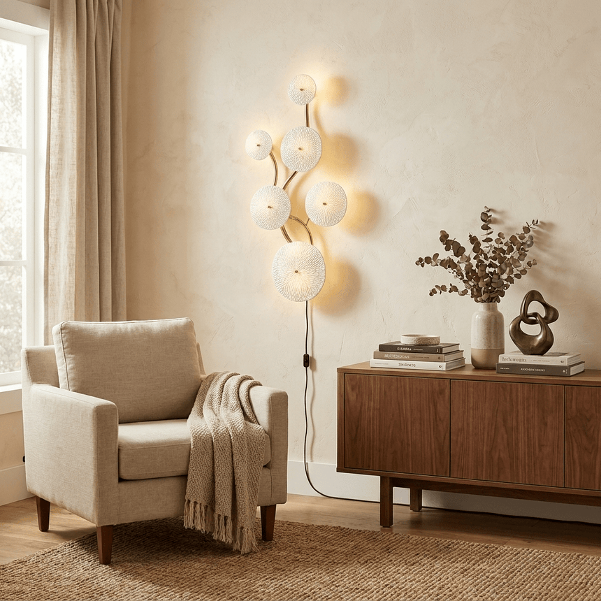 The vertical version lit beside a cream armchair, its cord running to the floor