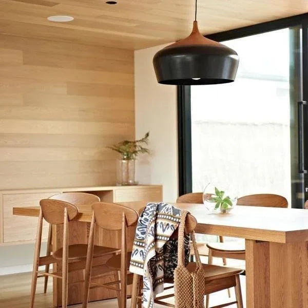 Dome ceiling light in black aluminum above a wooden table